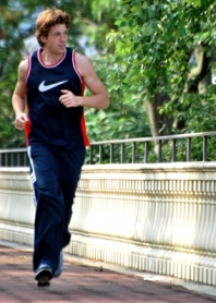 A man jogging across a bridge