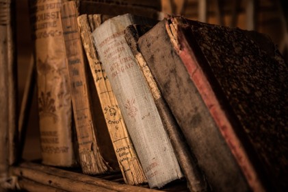 Old, dusty Books On a Bookshelf